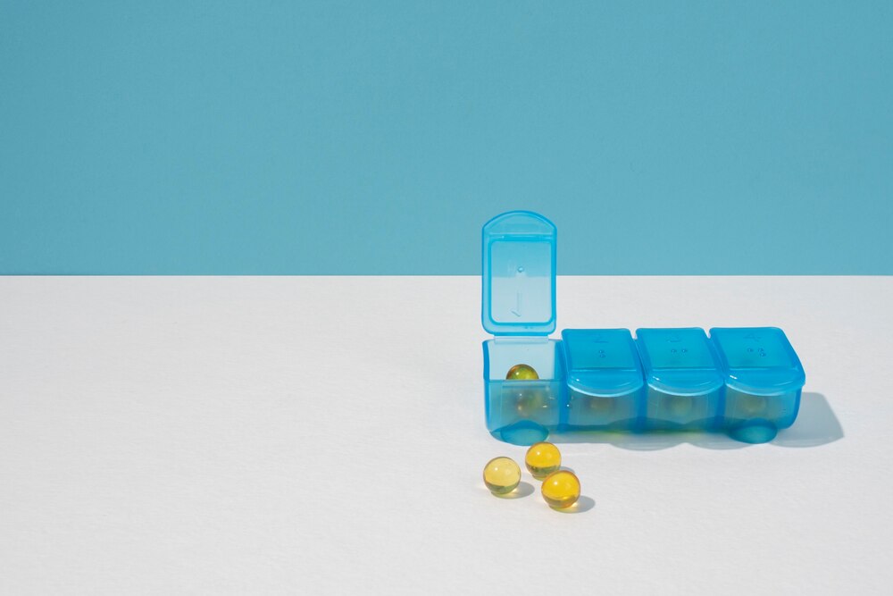 Pills container on white table